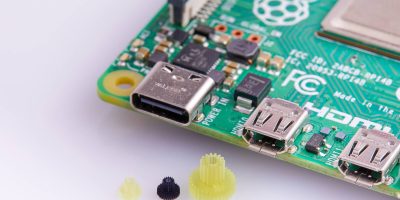 Micro 3d printed parts next to a chipboard