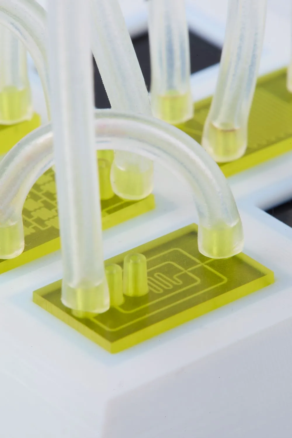 Clear tubes connected to yellow 3D printed micro tubes using our rapid prototyping technology.