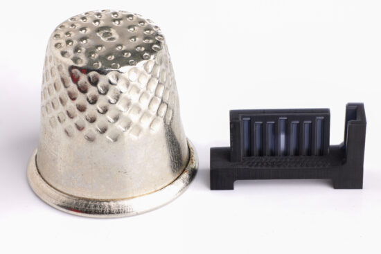 25 micron 3d printing part next to a thimble